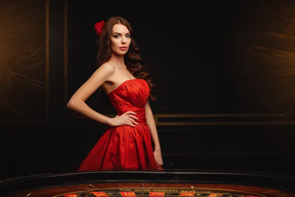 A young woman relaxing with her phone while dynamic casino elements float around her, illustrating the smooth mobile experience offered by the JILI696 app.